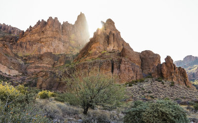 The sun appears over a Superstition Mountain peak in Tonto National Forest