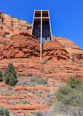 Deep blue sky and red rocks frame the Chapel of the Holy Cross in Sedona Arizona