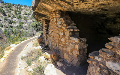 Cliff dwellings round a bend along the Island Trail in Walnut Canyon National Monument