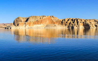 Rocky butte reflected in Wahweap Bay in Glen Canyon NRA