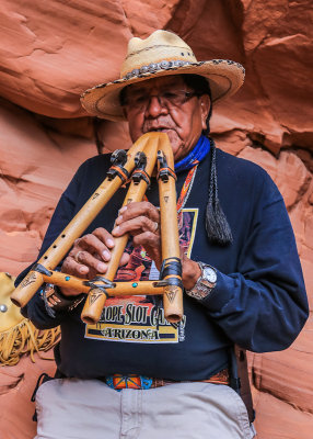 Tour Guide Leonard Nez plays a Native Indian flute at the entrance to Antelope Canyon
