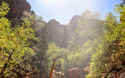 Zion Canyon mountains from under a waterfall along the Emerald Pools Trail in Zion National Park