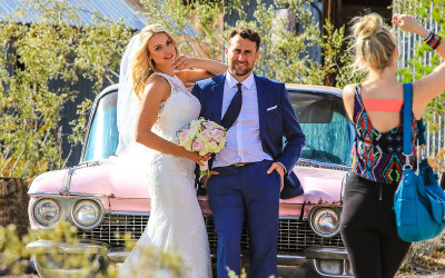 Wedding couple in front of a pink Cadillac in El Dorado Canyon, Nelson Nevada