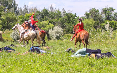 Indian Nation warriors ride among the 7th Cavalry dead at the Battle of the Little Bighorn