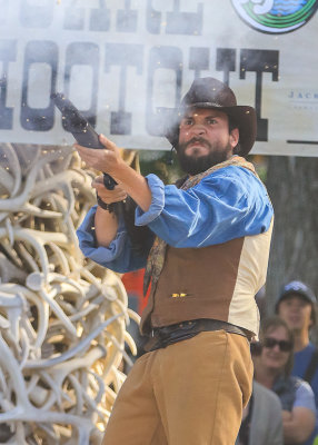 Firing both barrels in the Town Square Shootout in Jackson Hole Wyoming