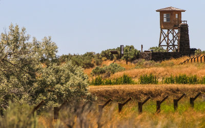 View of entrance guard tower and barbed wire fence in Minidoka National Historic Site