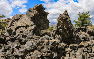 View through rugged lava rock along the Devils Orchard Nature Trail in Craters of the Moon National Monument