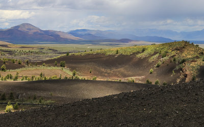 A storm moves across the Pioneer Mountains as seen from the top of the Inferno Cone in Craters of the Moon National Monument