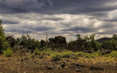 Storm clouds darken the skies along the Devils Orchard Nature Trail in Craters of the Moon National Monument