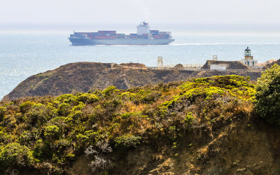 A container ship passes the Point Bonita Lighthouse in Golden Gate National Recreational Area