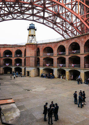 Lighthouse and parade ground under the Golden Gate Bridge in Fort Point National Historic Site