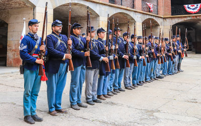 Troops present arms on the parade grounds in Fort Point National Historic Site