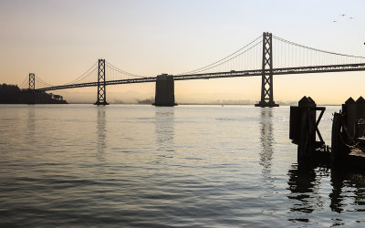 Early morning sunlight behind the San Francisco Oakland Bay Bridge in San Francisco