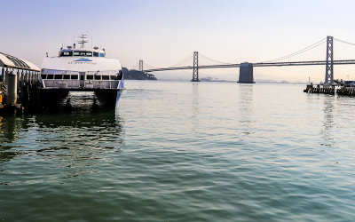 The San Francisco Bay Ferry with the San Francisco Oakland Bay Bridge in the distance in San Francisco