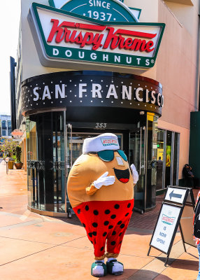 Krispy Kreme doughnut man in front of their newest store in San Francisco