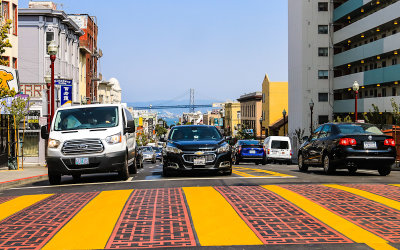 Street traffic with the San Francisco Oakland Bay Bridge in the distance in San Francisco