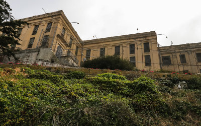 The fenced in cellhouse from below on Alcatraz Island