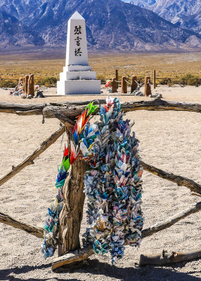 Memorial wreaths with the Cemetery Monument in the background in Manzanar National Historic Site