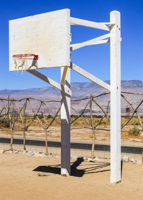 Guard Tower in the distance as seen from the Block 14 basketball court in Manzanar National Historic Site