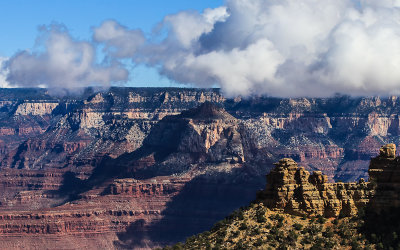 Clouds dip below the canyon rim as seen from the Pipe Creek Vista along the South Rim in Grand Canyon NP