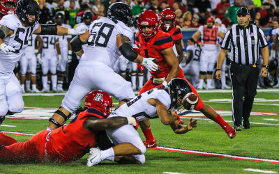 Wildcats DT PJ Johnson forces a Ducks RB Travis Dye fumble