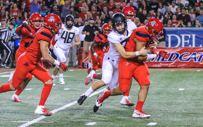 Arizona DE Kylan Wilbon recovers a blocked punt and is tackled by Oregon P Tom Snee