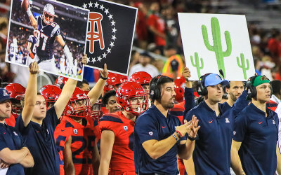 Arizona coaches signal in a play from the sidelines