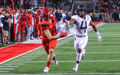 Wildcats Slot Receiver Tony Ellison tracks a pass over Ducks CB Thomas Graham