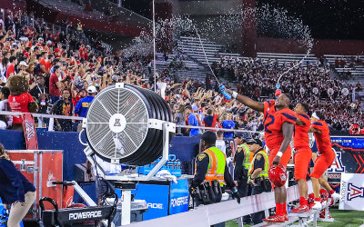 Arizona DE JB Brown spays the fans with water as the upset celebration begins