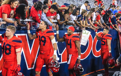 Cats WR Poindexter (19) and QB Tate (14) thank the fans after the game