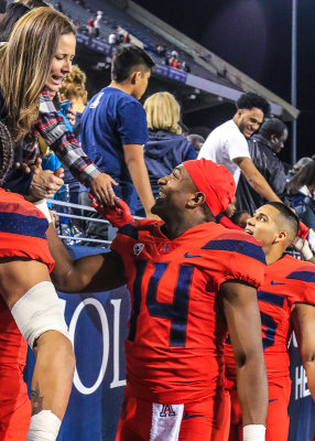 Arizona QB Tate is congratulated by a fan after the game