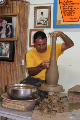 A pottery factory employee demonstrated his trade. 