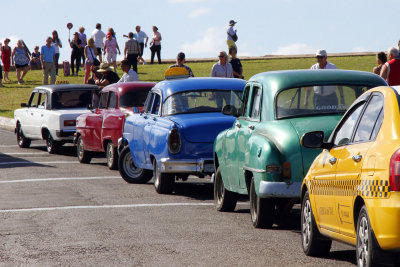 Cars parked at El Morro - taxis, classic American car taxis, Russian Ladas
