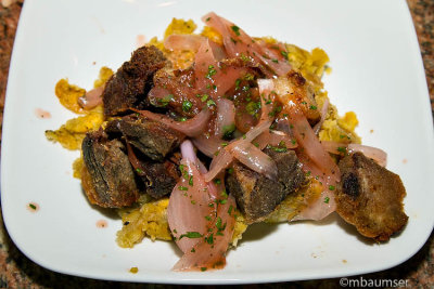 Carne frita with guava & onion sauce over mofongo
