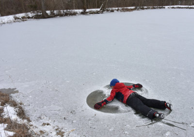 Geo making snow angels on the pond