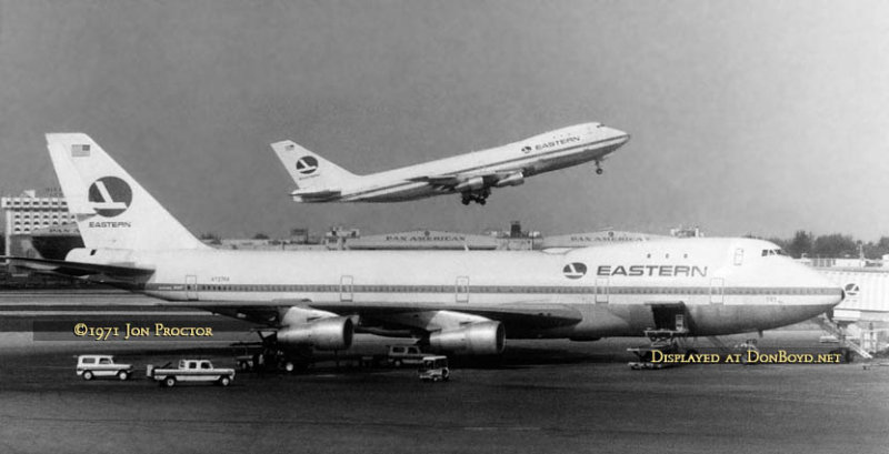 1971 - Eastern B747-121 N731PA taking off from runway 9L beyond Eastern B747-121 N737PA parked on the end of Concourse 5 at MIA