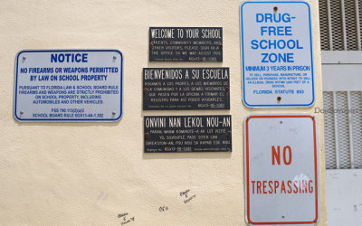 The exterior signs on the front of the old open area in the center of the south side of Hialeah High School