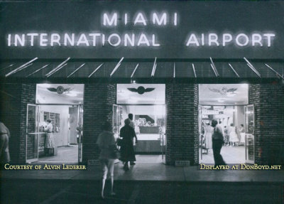 1957 - Entrance to the 36th Street Terminal at Miami International Airport at night with neon lighting