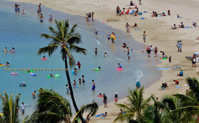 2010 - beachgoers at the public beach next to the Hilton Hawaiian Village as seen from the Hale Koa military resort