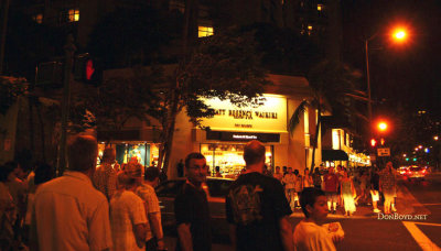 Tourists out and about at night by the Hyatt Regency Waikiki