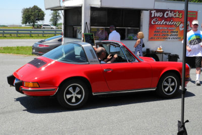 A 1973 Porsche 911 S Targa parks next to the Two Chicks Catering food truck. (1044)