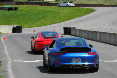 2018 Porsche 911 T leads a 2018 911 4S around the race track. (2658)