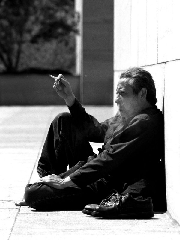 Man smoking in front of the Air and Space Museum in Washington, DC