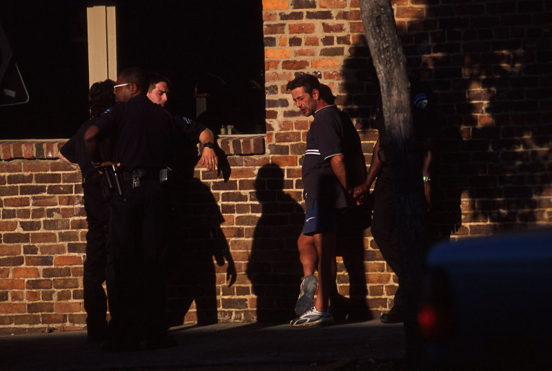 four cops and a dude in the evening sun