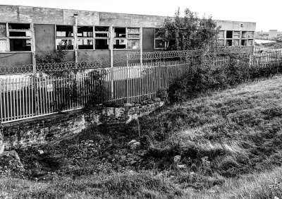 Wallsend - a few stones of the Wall are visible, running under a disused building (9/28/2018)