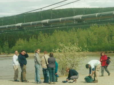 The group admiring a section of pipeline on a bridge