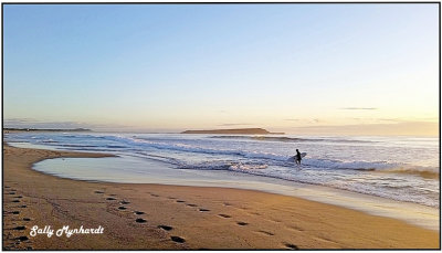 A lone surfer on Warilla Beach.