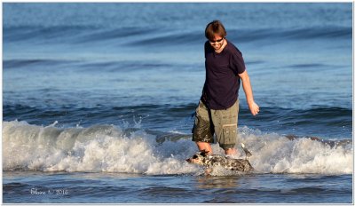 This is an older shot of our eldest son, Greg
with Opal enjoying a splash in the waves at our local beach.