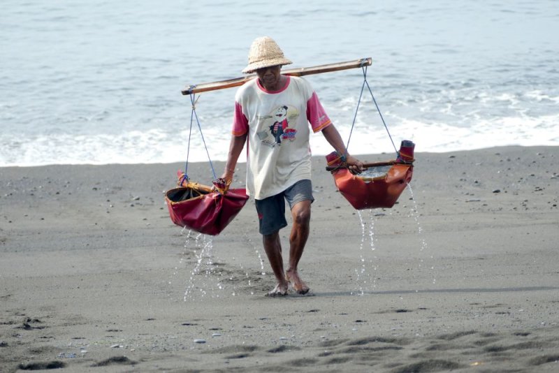 A salt maker on a black sand beach