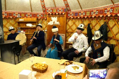 Musicians performing at a dinner in a Yurt. The singer is singing a Manas, a legendary epic recounting the history of the Kyrgyz